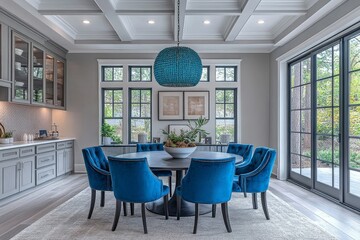 Fototapeta premium Dining room with blue chairs, black dining table, light gray walls, and aqua chandelier, reflecting modern style in a traditional American home interior.