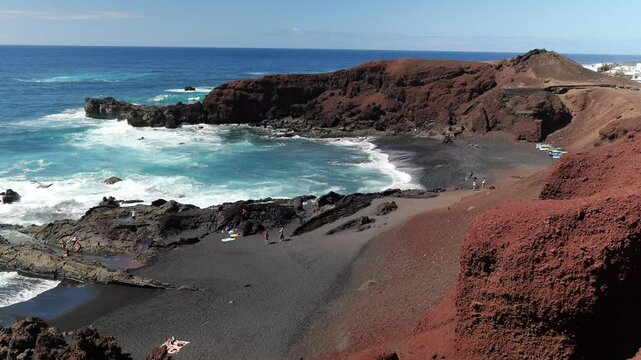 El Golfo Spain 03 11 2025 The rugged coast of El Golfo, Lanzarote, near Charco Verde. People enjoy the sea and shoreline, surrounded by volcanic cliffs and the stunning Atlantic Ocean views.