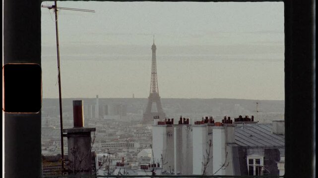 Eiffel tower emerging from parisian rooftops in super 8 film style