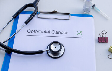 A medical clipboard displaying a positive colorectal cancer test result, accompanied by a stethoscope on a doctor’s desk.