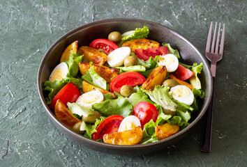 Salad with potatoes, tomatoes, olives and eggs. Healthy food. Vegetarian food.