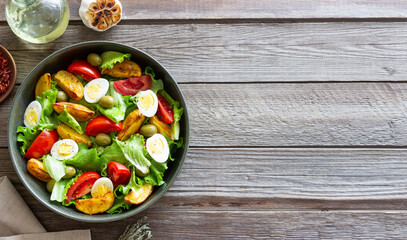 Salad with potatoes, tomatoes, olives and eggs. Healthy food. Vegetarian food.