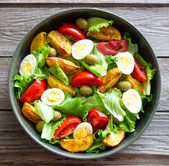 Salad with potatoes, tomatoes, olives and eggs. Healthy food. Vegetarian food.