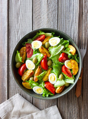 Salad with potatoes, tomatoes, olives and eggs. Healthy food. Vegetarian food.