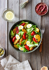 Salad with potatoes, tomatoes, olives and eggs. Healthy food. Vegetarian food.