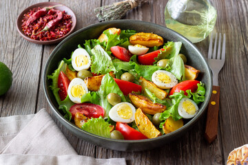 Salad with potatoes, tomatoes, olives and eggs. Healthy food. Vegetarian food.