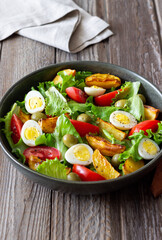 Salad with potatoes, tomatoes, olives and eggs. Healthy food. Vegetarian food.