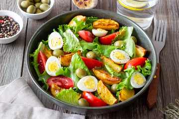 Salad with potatoes, tomatoes, olives and eggs. Healthy food. Vegetarian food.