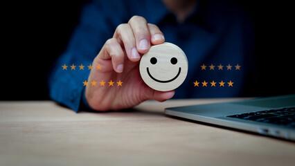 User holding a wooden block with smil face. Around wooden block, 5 stars symbolize a customer...