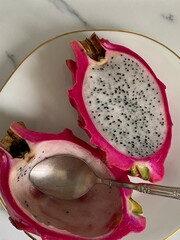 Cut white dragon fruit on marble table top view closeup