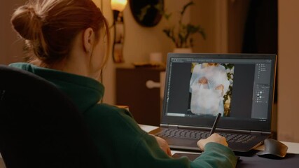 Woman is engaged in the creative process of editing images on her laptop using a graphics tablet. Her home studio is warm and inviting, showcasing her design skills. - Powered by Adobe