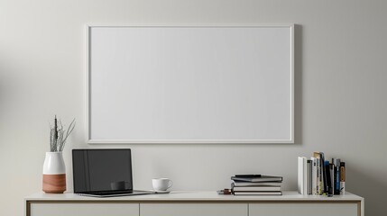 A white rectangular frame hanging above a hallway console with a cup, a laptop, and a few books. HD 8K mockup wallpaper Photographic Image
