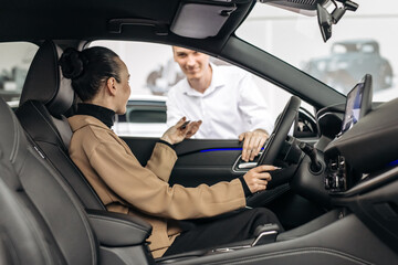 The completion of a car purchase or rental deal, with the handover of keys. Concept the final step...