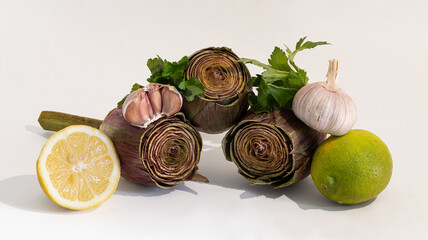 Still life with artichokes, lemons and garlic.