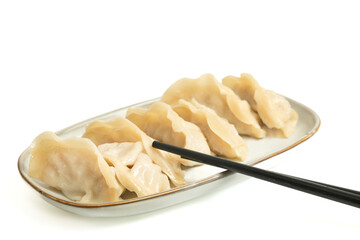 Steamed gyoza dumplings on white background