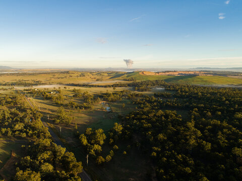 Distant open cut mine on the horizon and power station water vapor