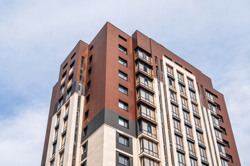 Fototapeta premium A modern and new residential building. Multi-storey modern, new and stylish residential complex against the sky