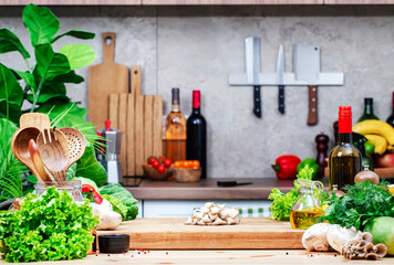 Food background. Healthy eating, cooking, blogging scene. Оak cutting board with oyster mushrooms, vegetables and herbs on cozy kitchen with wooden table, kitchenware and utensils