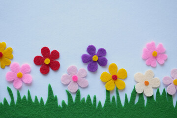 Spring felt flower meadow, handmade textile craft, colorful floral arrangement, DIY sewing project, green grass, soft petals, home decor, pastel theme, creative art