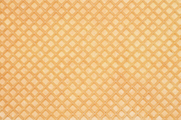 A close-up, full-frame shot of a wafer sheet texture, highlighting its detailed diamond pattern and light brown color
