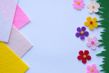 DIY felt floral craft, colorful handmade decoration, pastel background, creative textile design, soft petals, home decor, sewing project, spring-inspired composition, artistic craft