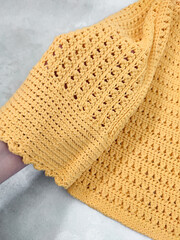 Yellow crochet sweater with flared long sleeves. Cuff in hand. Cotton openwork knitted pattern. Women's clothing, spring fashion collection, shopping, apparel, clothes cleaning, care, handmade blouse 