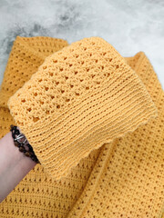 Yellow crochet sweater with flared long sleeves. Cuff in hand. Cotton openwork knitted pattern. Women's clothing, spring fashion collection, shopping, apparel, clothes cleaning, care, handmade blouse 