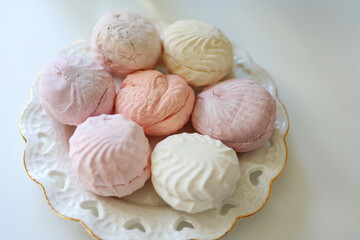 Close-up of gourmet zefir served on a lacy white porcelain dish