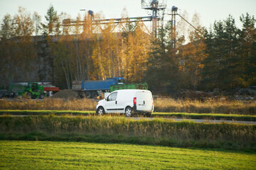 Cargo vehicle driving alongside forest