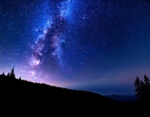 Obraz premium Vibrant night sky filled with stars and the Milky Way over a forested landscape at dusk