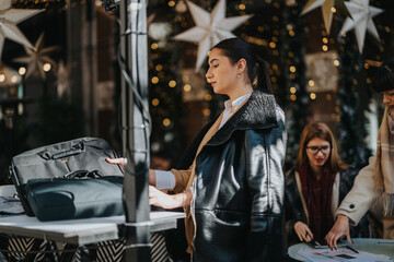 Women at an outdoor event showcasing a mix of professionalism and festive seasonal decor.
