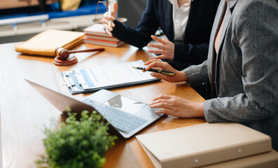 Business people compassionately holding hands and discussing contract papers with laptop