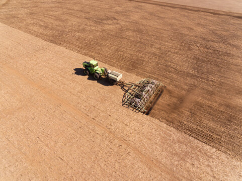 Aerial view of tractor and seeding bar planting crop