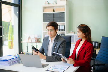 Happy businesspeople while collaborating on a new project in an office.