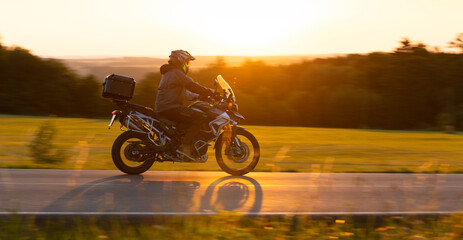 Motorcycle on the Road with Beautiful Sunset Light.