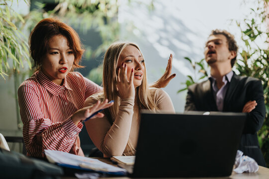 A group of business people expressing frustration and stress during a team meeting. The tense atmosphere depicts their struggle with a challenging situation in a professional setting.