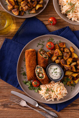 Pork chop rolls stuffed with spinach and mozzarella. Served with sun-dried tomatoes and roasted potatoes.