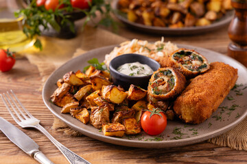 Pork chop rolls stuffed with spinach and mozzarella. Served with sun-dried tomatoes and roasted potatoes.