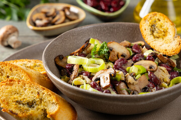 Spring salad with red beans and mushrooms. Served with croutons and garlic butter.