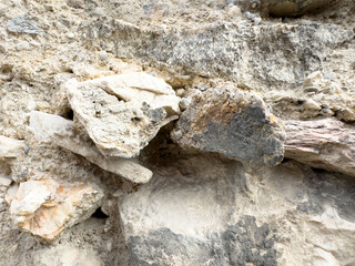 Rough textured sedimentary rock formation with layers of mineral deposits