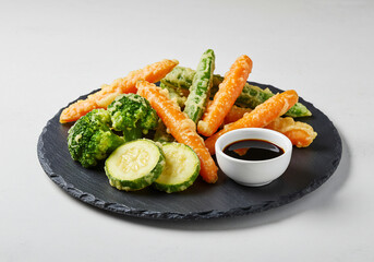 Tempura Vegetables with Soy Sauce on Black Slate Plate