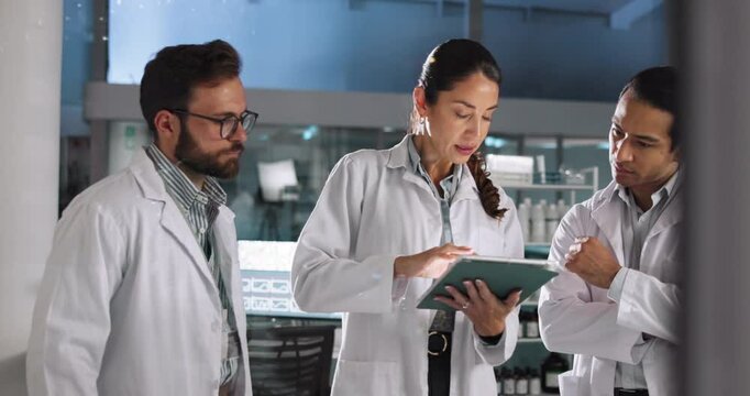 Scientist, teamwork and discussion with tablet in laboratory for pharmaceutical review, medical research or innovation. Night, people and clinical analysis of science data, study results and advice