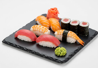Variety of Sushi Nigiri and Sashimi on Black Slate Plate