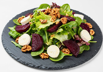 Vibrant Beetroot Goat Cheese Salad with Walnuts on Dark Plate