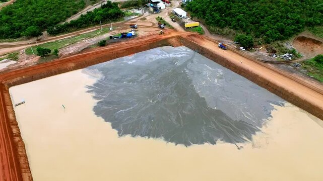Man-made containment area, tailings pond, mining operations, aerial