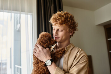 Young man shares tender moments in a cozy hotel room with his adorable pet