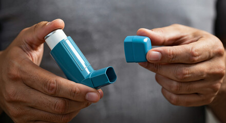 Asthma inhaler held by hands, medical device for respiratory treatment, healthcare and medication concept, chronic disease management and breathing assistance