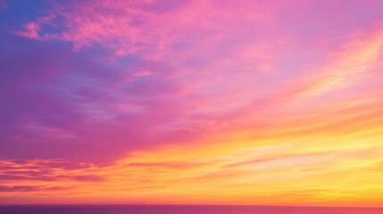 Obraz premium A vibrant sunset paints the sky with hues of pink, orange, and yellow, creating a breathtaking and colorful display.