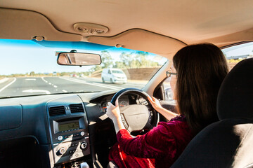 Young driver driving right hand drive car in Australia