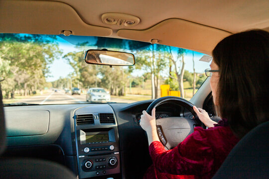 Young driver driving right hand drive car in Australia